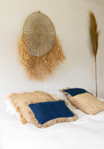 pillows on bed with wall decor