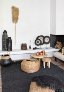 decor of baskets, lamps, stools, pillows in black, white and natural colours