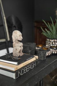 decor of books and figurine with black background