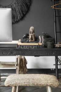 black table with books, figurines and bead baskets