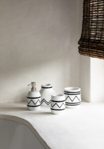 four vases and soap dispenser in white with black motif