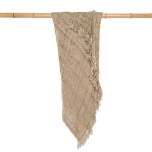 beige cotton thrown blanket hanging on bamboo stick