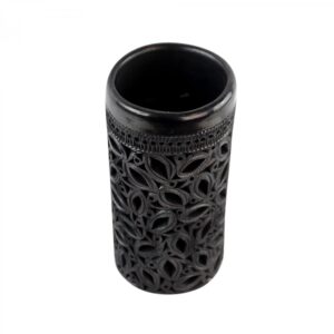black openwork vase photographed from above on white background