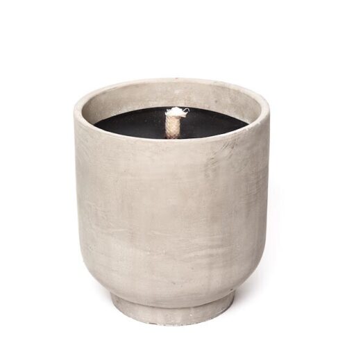 black candle in concrete bowl on white background