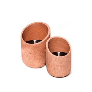two terracotta candles on a white background
