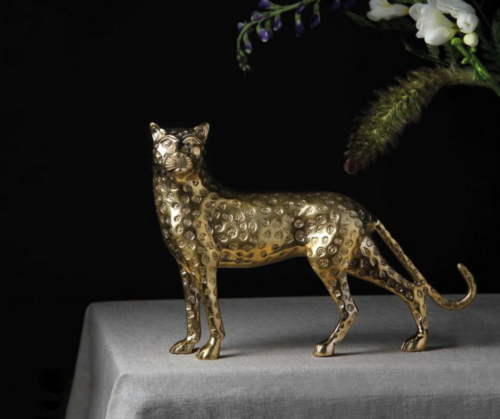 golden panther figurine with black background