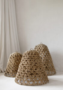 three seagrass lampshades standing on the ground together