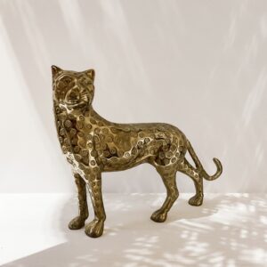 golden panther figurine on white background with light/shadow effects